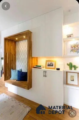 A kitchen with wooden cabinets and white counter tops, along with an island in the middle of the middle of the room with wood flooring and white counter top space to a kitchen filled with wooden cabinets and white